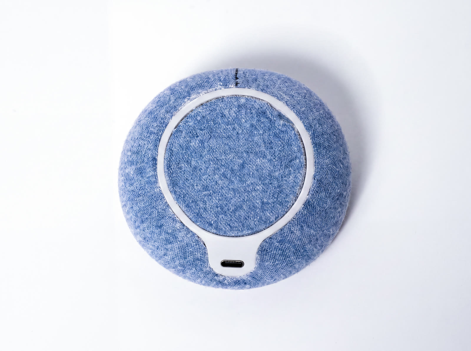 NEST from above, a rigid ring set into blue textile